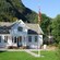 Large cottage with the flag of Norway in front yard